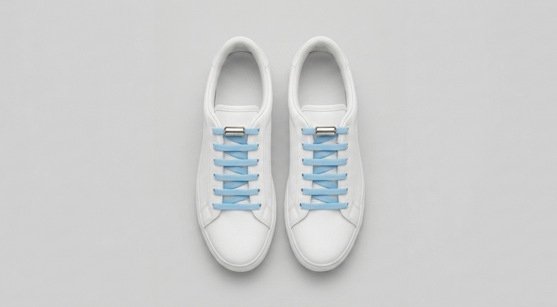 White sneakers with sky blue FreeTheLace elastic laces and silver metal capsule lock